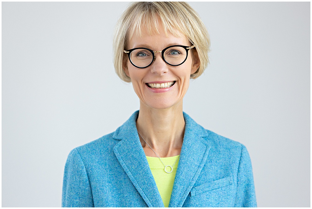 Modern Headshot of a woman in a turquoise blazer and cute glasses - Calm your nerves before a headshot session.