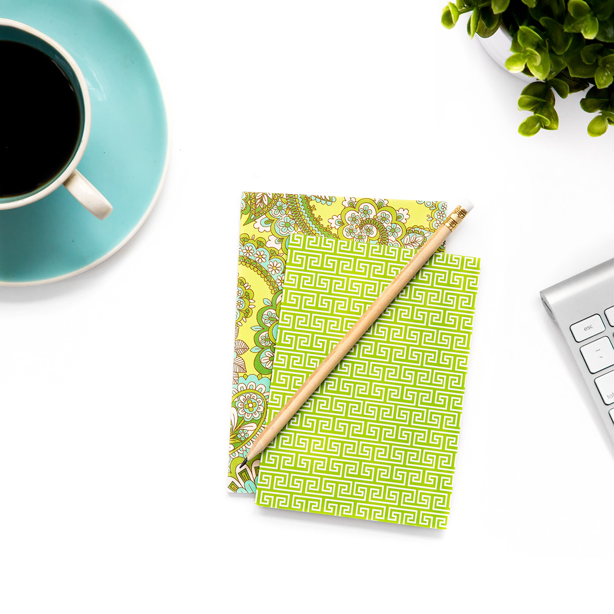 White Desktop with Blue Coffee Cup and Green Notebook