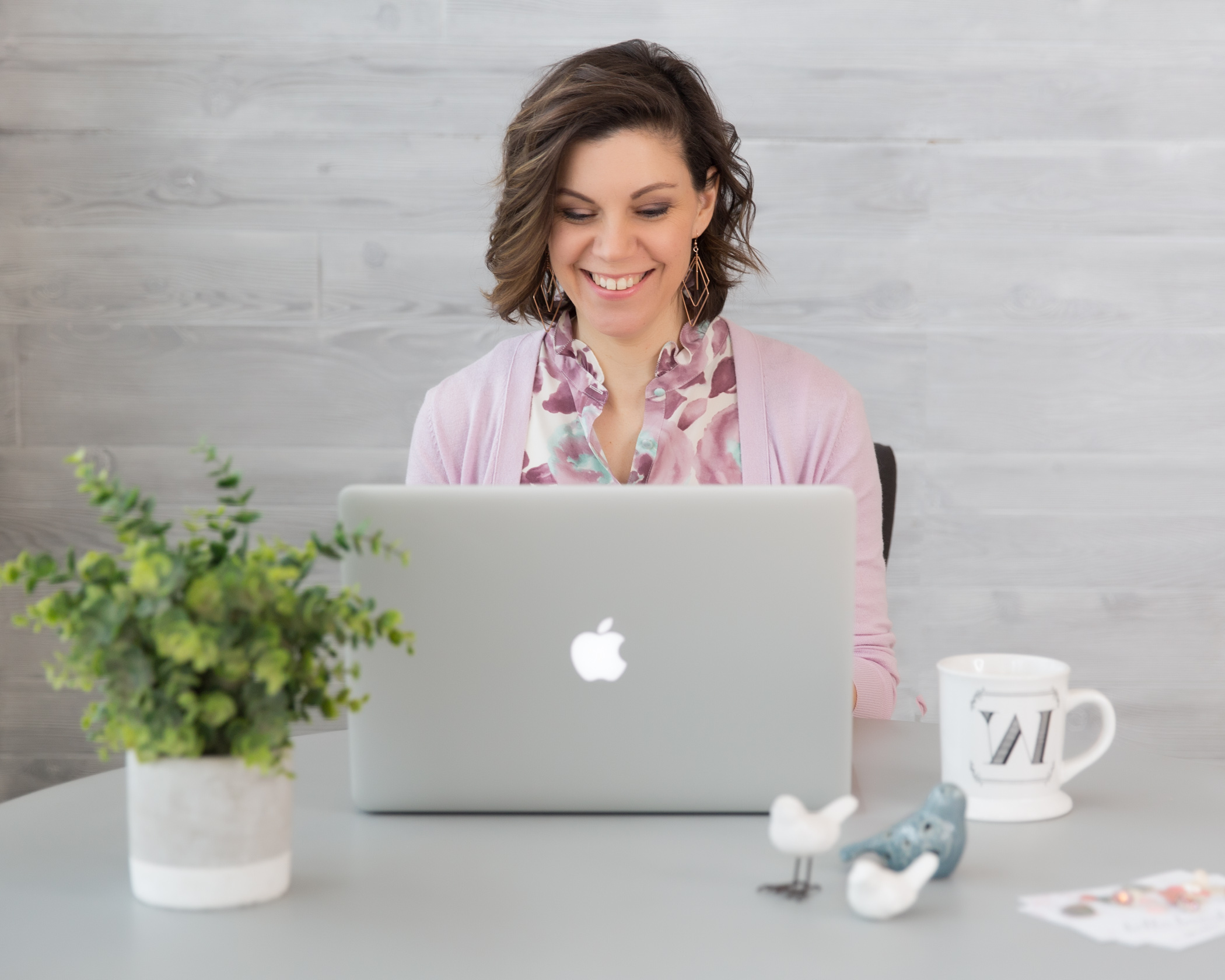 Woman entrepreneur working in a beautiful cardigan and blouse in her branding shoot