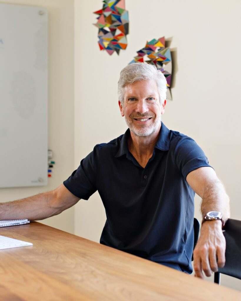 Male entrepreneur looking confidently at the camera in his brand shoot in Michigan.
