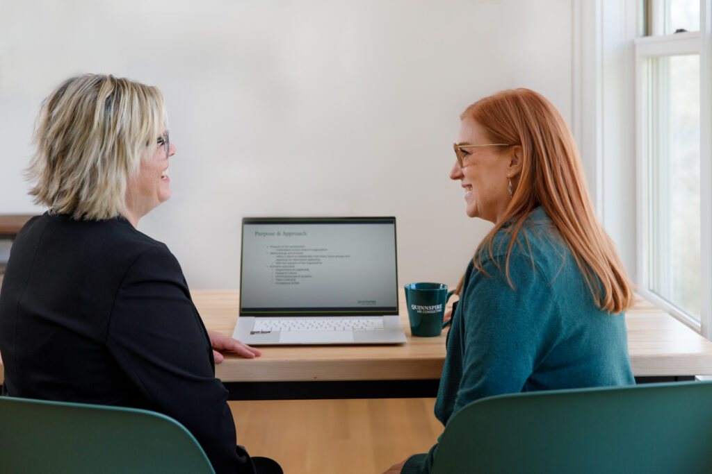 Over 40 woman HR consultant meeting with another worker in a friendly way.